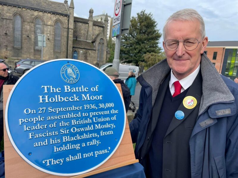 Hilary with the blue plaque to mark the Battle of Holbeck Moor